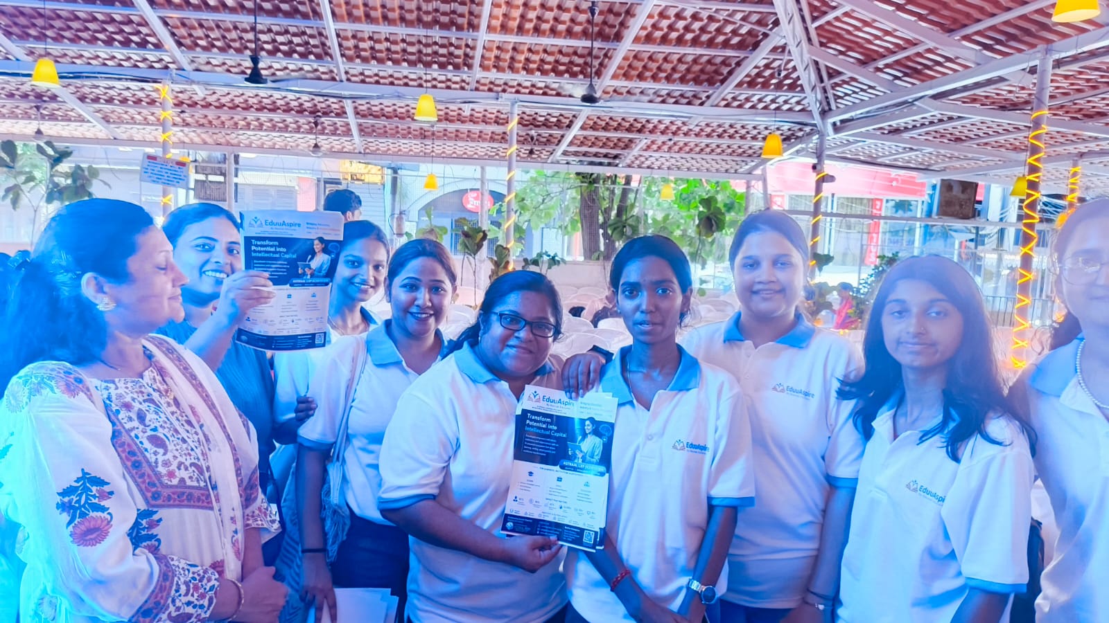 EduuAspire team displaying the transformation brochure